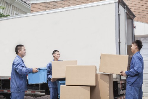 Boxes and furniture being loaded into a removal van