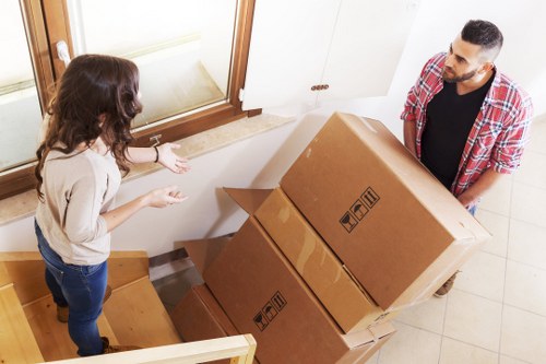 Removal team handling boxes with care during a van move