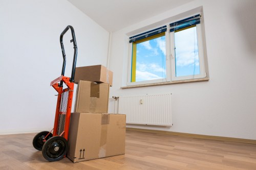 Professional movers handling furniture in a local Old Malden property