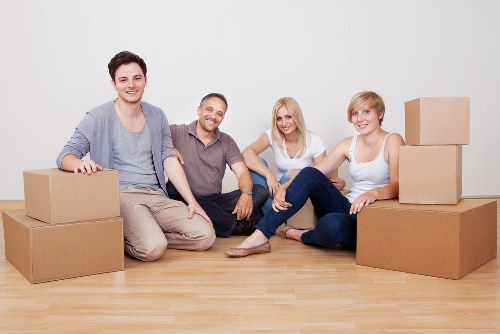 Professional movers packing household items for an Old Malden move