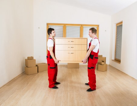 Residential moving day scene in an Old Malden property with careful item handling